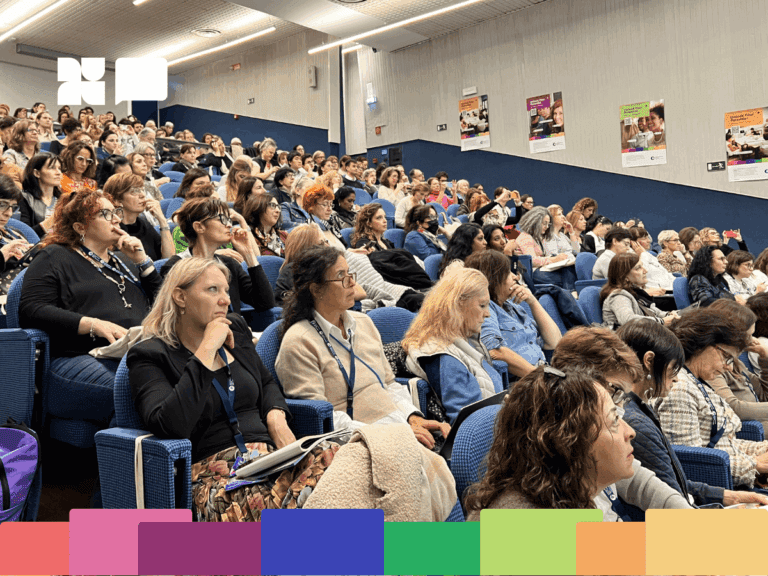 Audience at International House Milan conference looking at speaker.