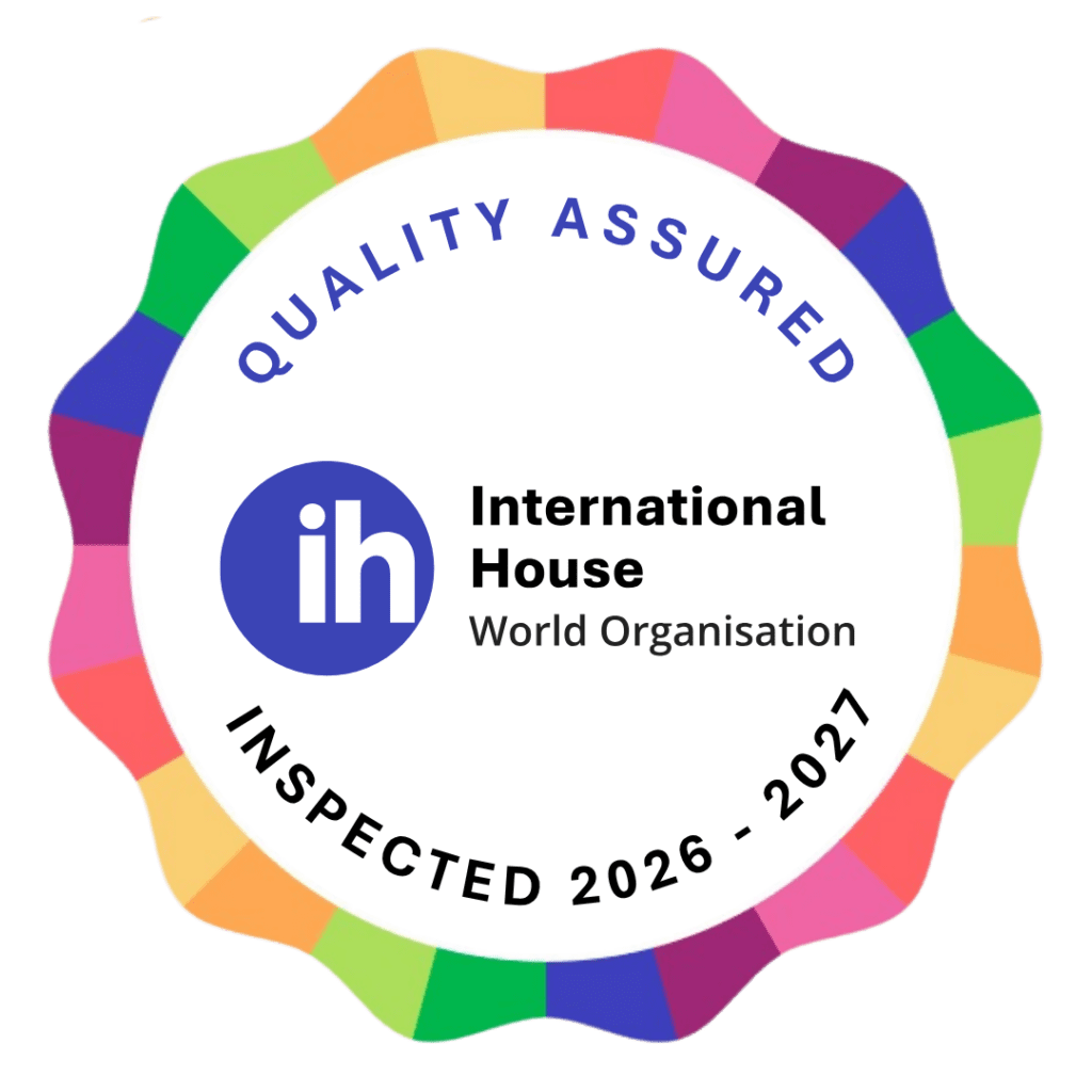 A circular badge with a colorful border, the words "Quality Assured," "Inspected 2026–2027," and the International House World Organisation logo in the center.